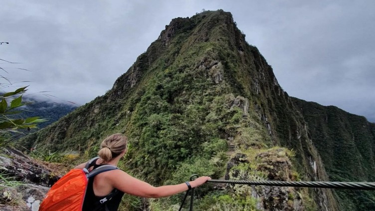 Georgia Beattie staring up at a mountain in Peru